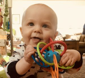 Baby with teether toy