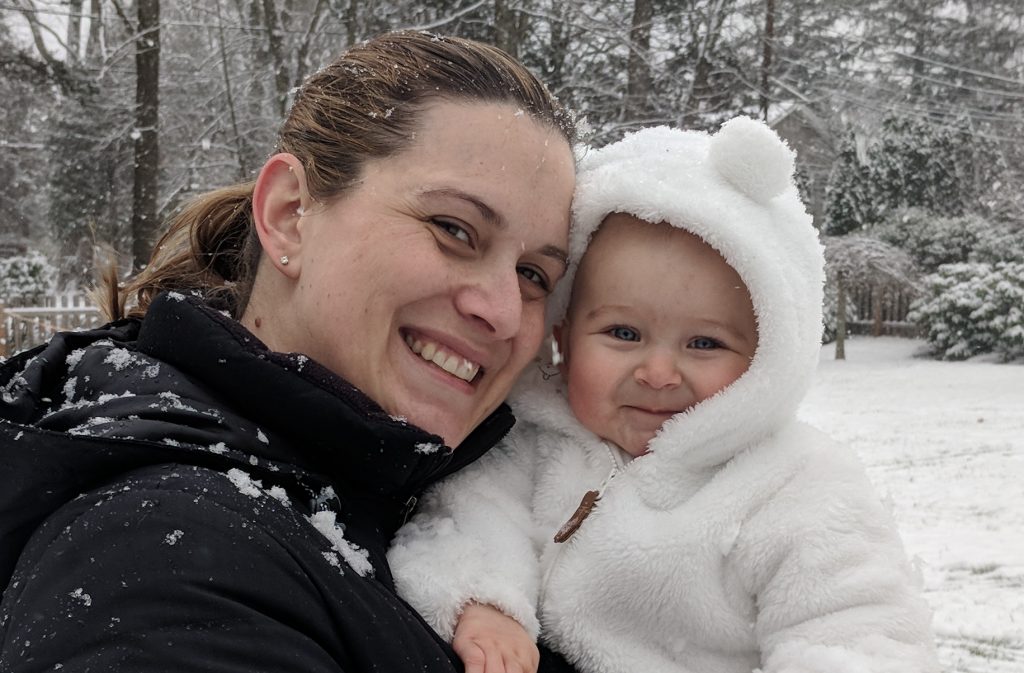 blond mother and baby in the snow