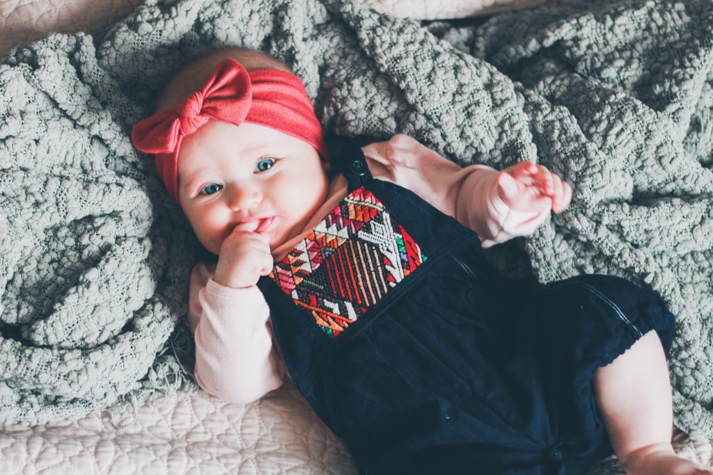 baby girl head band finger in mouth