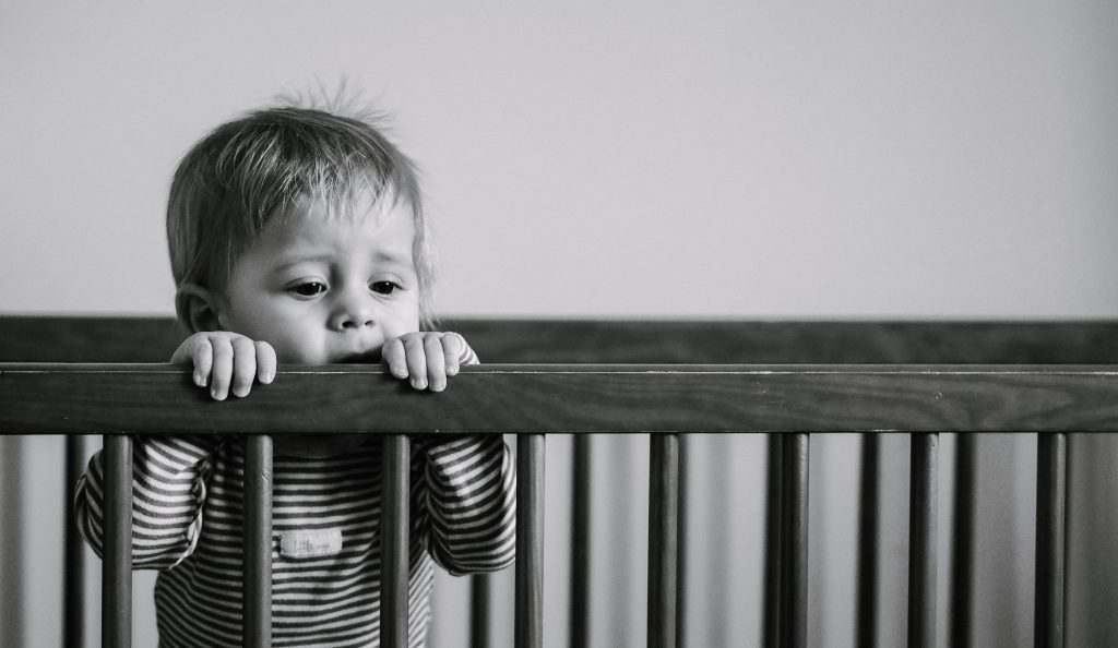 baby in crib grayscale