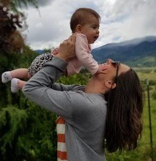 mom lifting baby girl